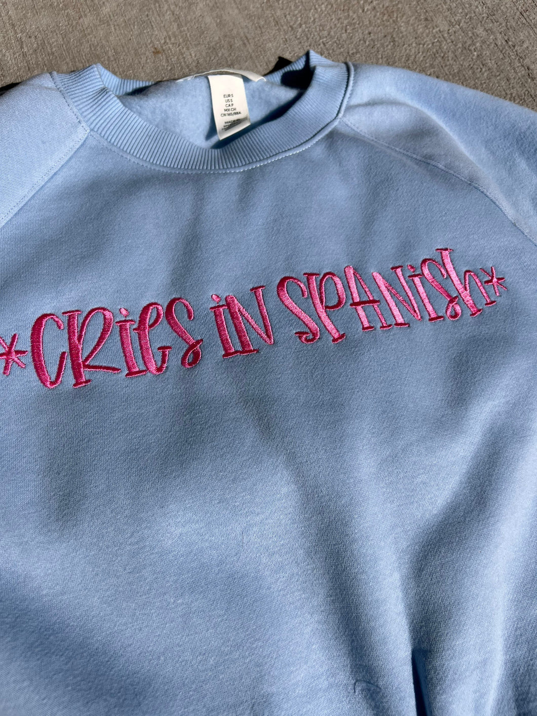 Cries in Spanish embroidered sweatshirt